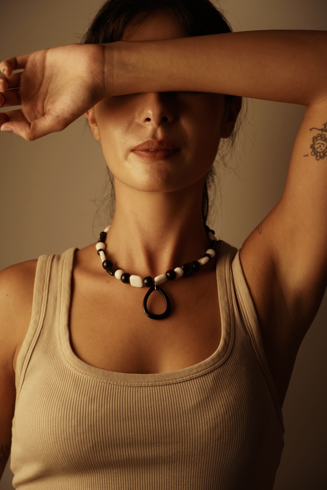 Editorial portrait with black and white necklace